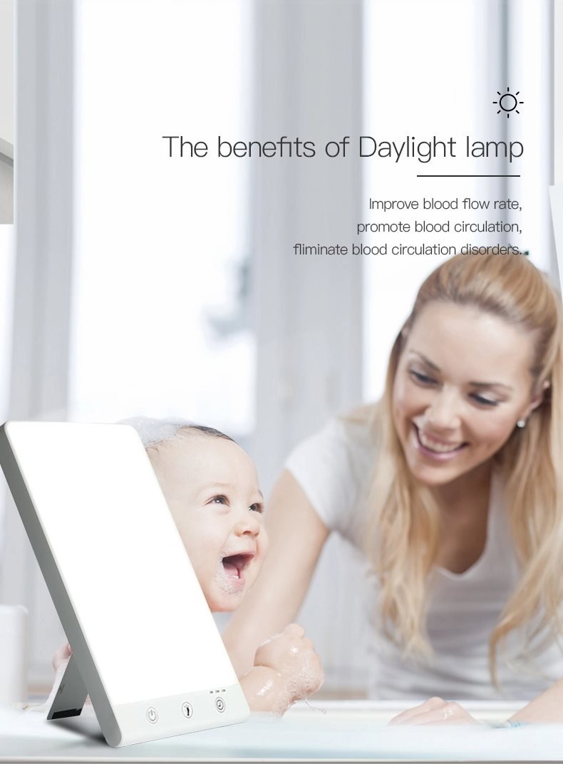 A woman smiles at a laughing baby in a bath next to the Fashiongirl Light Therapy Lamp 10,000 lux LED, which boosts blood flow and circulation to help ease winter depression.