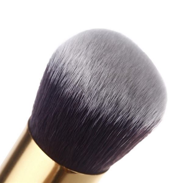 Close-up of the PRO Makeup Brush Set Black/Gold kabuki brush, featuring dense dark bristles and a shiny gold handle—part of a premium 10-brush set by PRO for flawless professional makeup application.