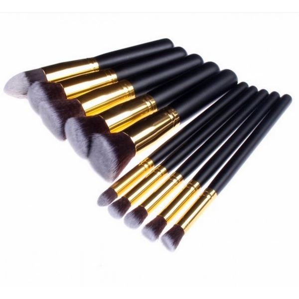The PRO Makeup Brush Set Black/Gold includes 10 premium kabuki and precision brushes with black handles and gold ferrules, arranged in two rows. This versatile PRO set features angled and rounded bristles for flawless application.