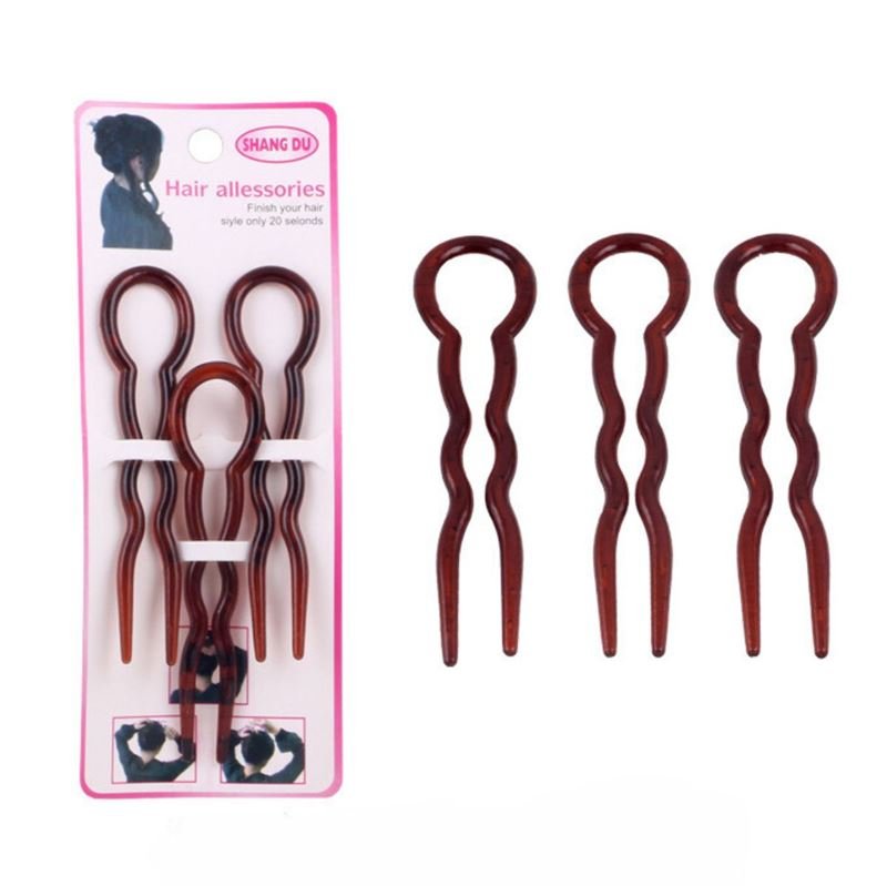 A pack of three brown Twist Chignon Hairpins by SOHO, featuring loops and wavy prongs, is shown with the unique hairpins both inside and outside the packaging.