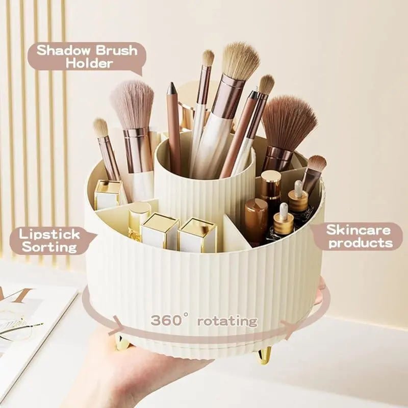 A hand holds the UNIQ Rotating Makeup Organiser in Cream White, featuring a 360-degree spin and labeled sections, neatly storing brushes, lipsticks, pencils, and skincare—perfect for easy cosmetics organisation by UNIQ.