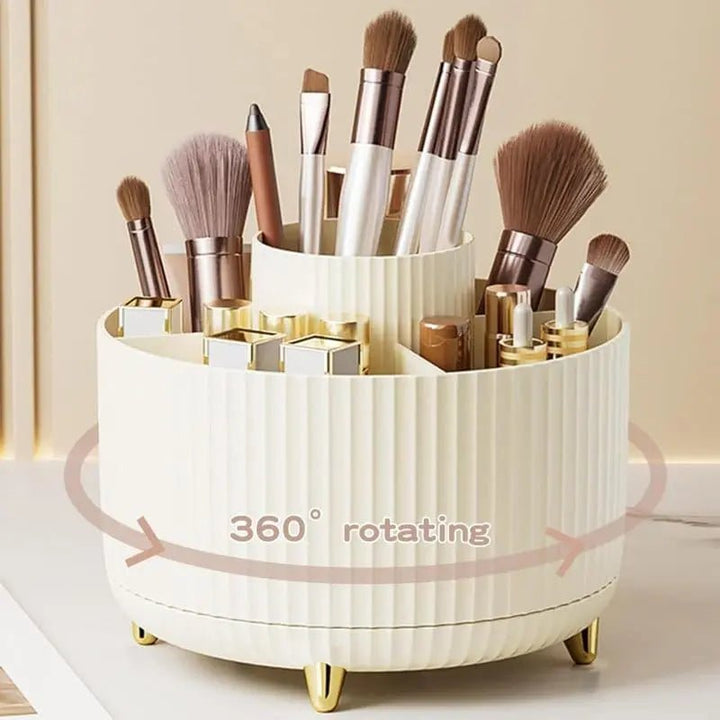 The UNIQ Rotating Makeup Organiser - Cream White by UNIQ features a ribbed design and holds brushes, lipsticks, and pencils. An arrow and “360° rotating” text highlight its smooth spin for effortless cosmetics storage.