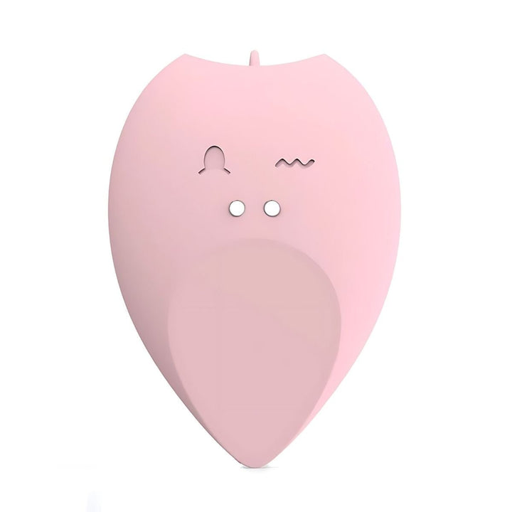 The Intimia Licking tear-drop vibrator is a pink, leaf-shaped clitoral stimulator with two small circular holes and engraved symbols, resembling a minimalist animal face, set against a white background.
