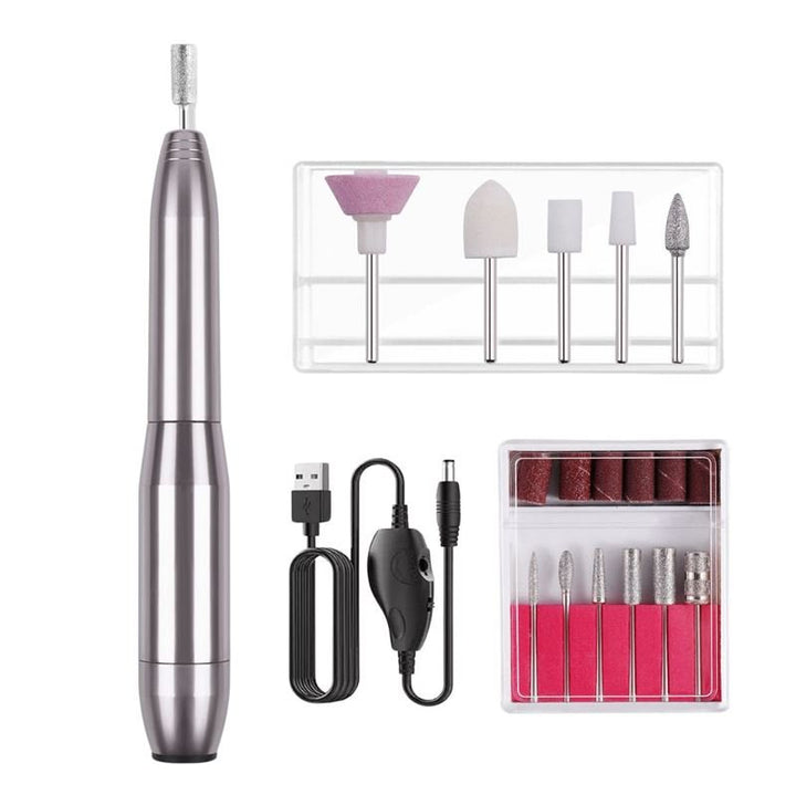The UNIQ Compact Electric Nail File Kit features a portable metallic pen-shaped e-file, multiple drill bits, sanding bands, USB charging cable, and control switch—perfect for salon-quality manicures and pedicures at home.